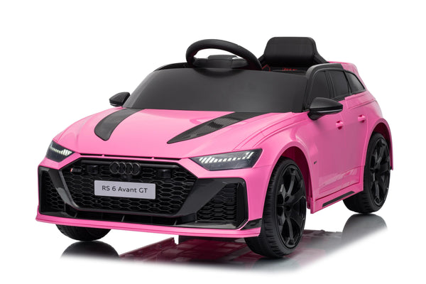 Audi RS6 Avant main image featuring pink, white and grey ride-on cars with Audi branding in the background