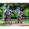 Two boys riding their bikes with stabilisers in the park