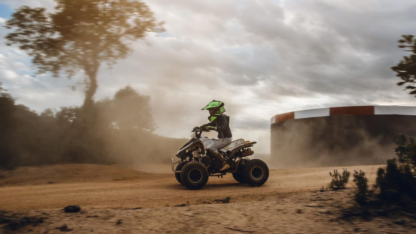 person on dirt track riding a quad bike